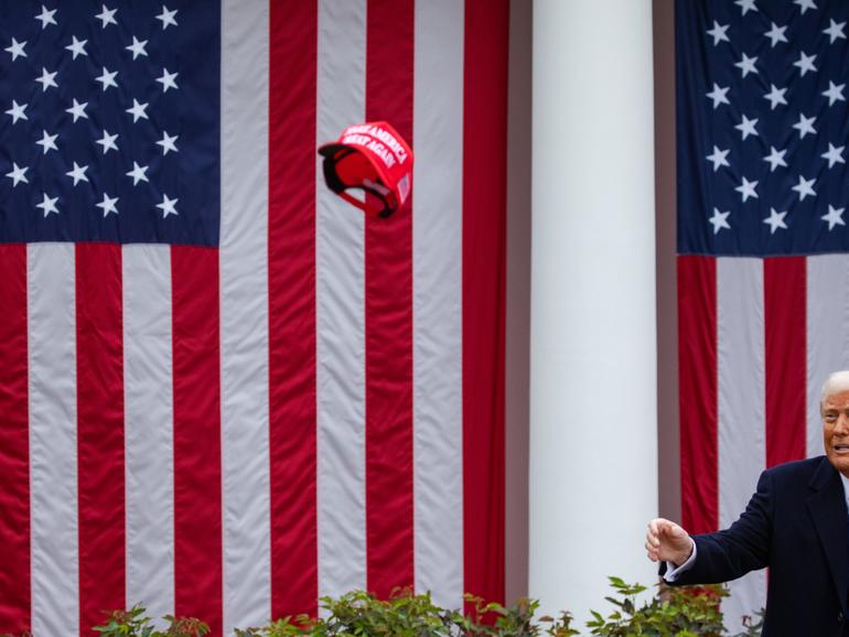 President Donald Trump tosses a MAGA hat at his event to sign tariffs, in the Rose Garden of the White House in Washington, on Wednesday, April 2, 2025. (Damon Winter/The New York Times)