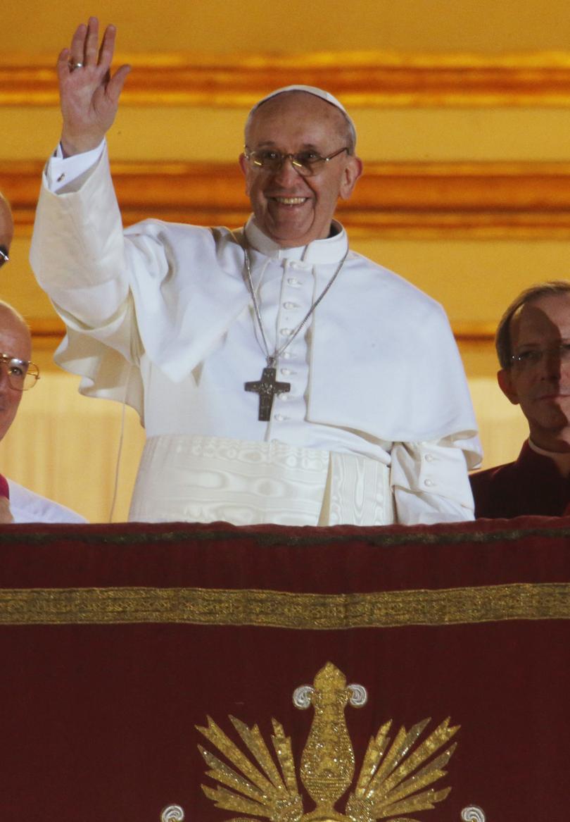Pope Francis waves to the crowd from the central balcony of St. Peter's Basilica at the Vatican after becoming the 266th pontiff of the Roman Catholic Church.