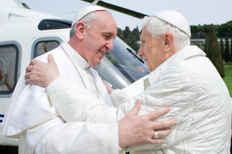 Pope Francis and his predecessor, Pope Emeritus Benedict XVI, meet at the helicopter pad of the papal summer residence, Castel Gandolfo on March 23, 2013 near Rome, Italy.
