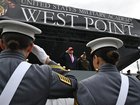 President Donald Trump, centre, salutes before speaking to US Military Academy graduating class of cadets during commencement ceremonies in West Point, NY.
